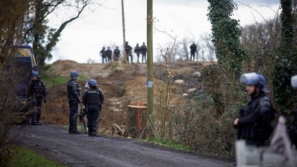 Mobile gendarmes (riot police) stand guard near the ZAD (Zone to Defend) to block access to it in the woods in Saix (Tarn), February 17, 2024. (ALAIN PITTON / NURPHOTO)