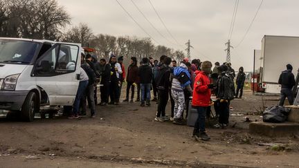 Des migrants assistent à une distribution de repas, à Calais (Pas-de-Calais), le 12 janvier 2018.&nbsp; (PHILIPPE HUGUEN / AFP)