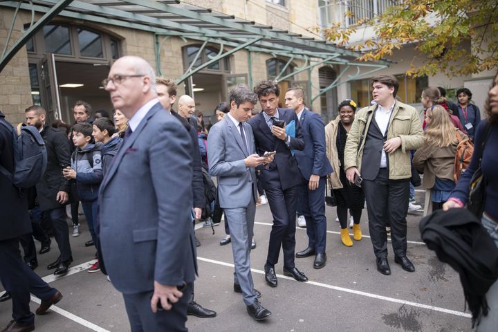 Louis Jublin speaks in the ear of Minister Gabriel Attal, November 9, 2023, during a visit to a school in Paris.  (ELIOT BLONDET / SIPA)