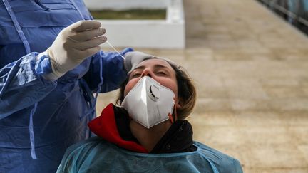 Un médecin&nbsp;prélève&nbsp;un échantillon sur une femme pour des tests Covid-19 dans une rue du gouvernorat de l’Ariana, à 6 km de la capitale Tunis, le 8 janvier 2021.&nbsp; (CHEDLY BEN IBRAHIM / NURPHOTO)