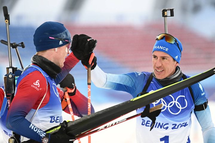 Quentin Fillon Maillet,&nbsp;quatrième de la mass start, salue l'autre grand homme de ces Jeux olympiques de Pékin en biathlon, Johannes Boe, vainqueur de&nbsp;cette ultime épreuve, le 18 février 2022, (Jewel SAMAD / AFP)