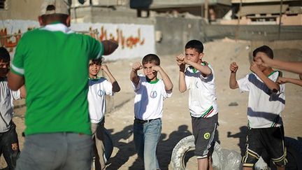 Selon Mohammad al-Chawa, moniteur dans un camp, l'objectif est «le divertissement, l'éducation et l'apprentissage des arts martiaux rudimentaires». (AFP PHOTO / MOHAMMED ABED)