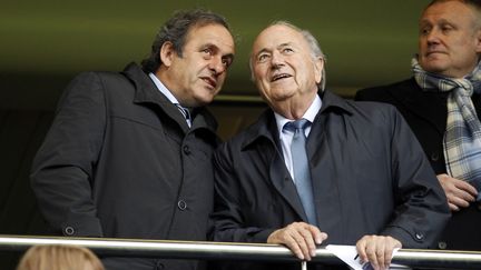 Michel Platini, président de l'UEFA, et Sepp Blatter, président de la FIFA, photographiés ici ensemble le 23 mai 2013 à Londres (Royaume-Uni). (IAN KINGTON / AFP)