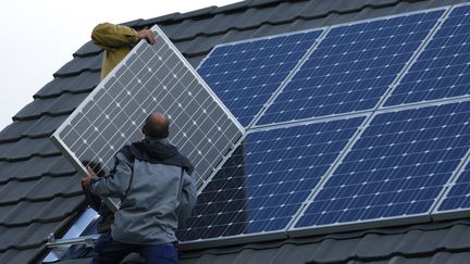 Un homme installe des panneaux photovolta&iuml;ques sur une maison, le 3 mai 2015, en Moselle.&nbsp; (THIERRY GRUN / ONLY FRANCE / AFP)