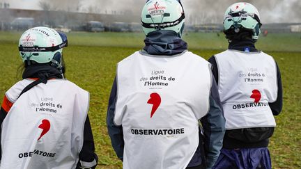 Three activists from the League for Human Rights (LDH) observe the demonstration and violent actions between anti-basin activists and the police in Sainte-Soline (Deux-Sèvres), March 25, 2023. (FREDERIC PETRY / HANS LUCAS / AFP)