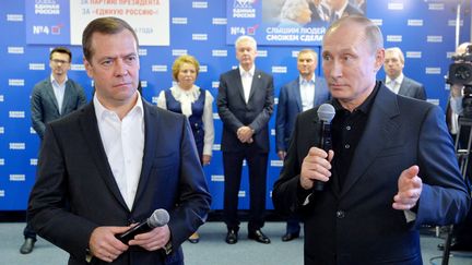 Le président russe Vladimir Poutine (D) et le Pemier ministre Dmitri Medvedev (G), au QG du parti Russie Unie, à Moscou, le&nbsp;18 septembre 2016.&nbsp; (ALEXEI DRUZHININ / SPUTNIK / AFP)