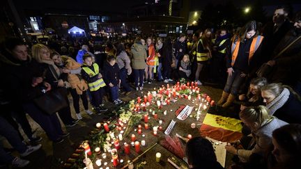 Des personnes sont rassemblées autour de bougies et de fleurs à l'aéroport de Bruxelles à Zaventem (Belgique), le 23 mars 2016. (YORICK JANSENS / BELGA / AFP)