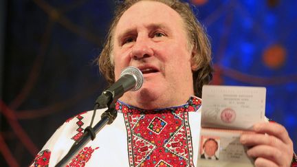 le com&eacute;dien fran&ccedil;ais G&eacute;rard Depardieu montre son passeport russe lors d'une c&eacute;r&eacute;monie de bienvenue &agrave; Saransk (Russie), le 6 janvier 2012. (REUTERS)