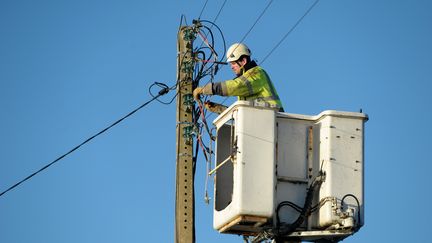 Un technicien tente de rétablir l'électricité à Tregunc, dans le Finistère, le vendredi 13 janvier.&nbsp; (Illustration / FRED TANNEAU / AFP)