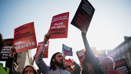 Demonstrators protest on the sidelines of the TotalEnergies general meeting on March 26, 2023 in Paris.  (CLAIRE JAILLARD / HANS LUCAS / AFP)