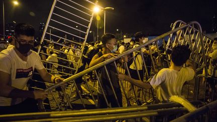 Des manifestants bloquent des routes avec des barricades lors d'affrontements avec la police après un rassemblement contre une proposition de loi controversée sur l'extradition à Hong Kong le 10 juin 2019. (ISAAC LAWRENCE / AFP)