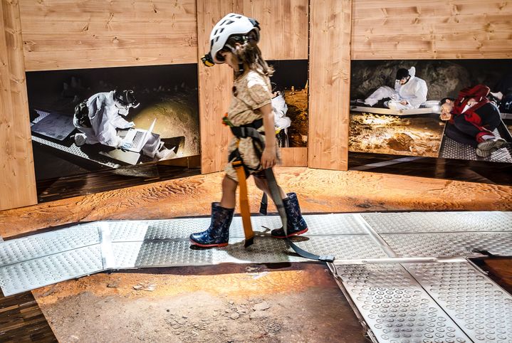 Une fillette se met dans la peau d'un chercheur dans l'exposition "Grotte Chauvet, l'aventure scientifique", à la Cité des sciences et de l'industrie, en octobre 2024. (ARNAUD ROBIN / EPPDCSI)