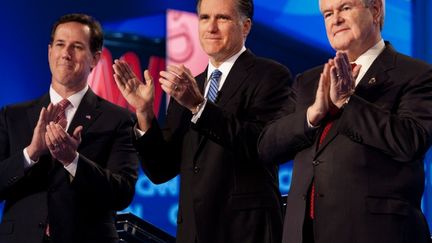 Mitt Romney (au c.), favori dans la course &agrave; l'investiture r&eacute;publicaine, entour&eacute; de ses deux principaux adversaires, Newt Gingrich (&agrave; dr.) et Rick Santorum (&agrave; g.), lors d'un d&eacute;bat t&eacute;l&eacute;vis&eacute; &agrave; Charleston, Caroline du Sud (Etats-Unis)) le 19 janvier 2012. (PAUL J. RICHARDS / AFP)