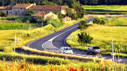 Des voitures se croisent sur une route de campagne. (GERARD HOUIN / MAXPPP)