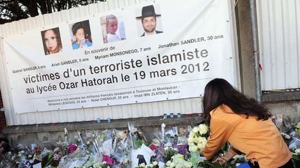 Des fleurs déposées en hommage aux victimes devant l'école Ozar Hatorah, à Toulouse (Haute-Garonne), le 25 mars 2012. (ERIC CABANIS / AFP)