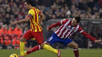 Xavi (FC Barcelone) échappe à Koke (Atletico Madrid) (DANI POZO / AFP)