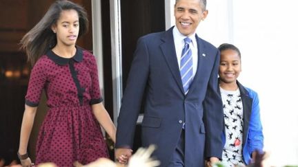 Malia Obama ( à gauche) avec son père à la sortie d'une église à Washington le 31 Mars 2013  (Photo Reuters/Yuri Gripas)