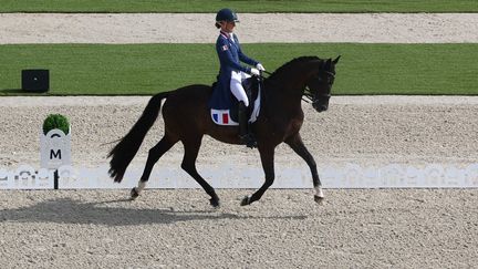 Frenchwoman Pauline Basquin and her horse Sertorius compete in the dressage equestrian event of the Individual Freestyle Grand Prix to Music during the Paris 2024 Olympic Games at the Palace of Versailles in Versailles on August 4, 2024. (PIERRE-PHILIPPE MARCOU / AFP)
