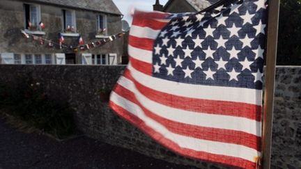 Les habitants de Colleville-sur-mer ont décoré leurs rues avec des drapeaux français et américains (© AFP)