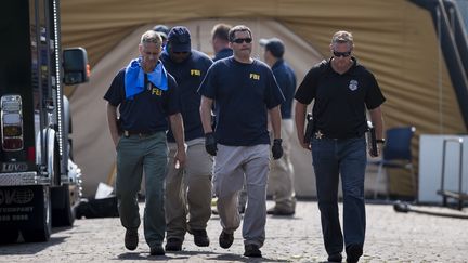 Des enquêteurs sortent du Pulse, club gay visé par un attentat dimanche 12 juin 2016 à Orlando (Floride). (BRENDAN SMIALOWSKI / AFP)