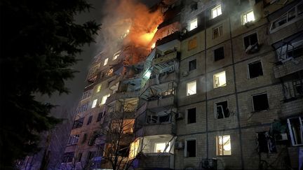 A photo released by Ukrainian rescue services showing a building on fire after a Russian strike in Kryvyi Rig, Ukraine, March 12, 2024. (UKRAINIAN EMERGENCY SERVICE / AFP)