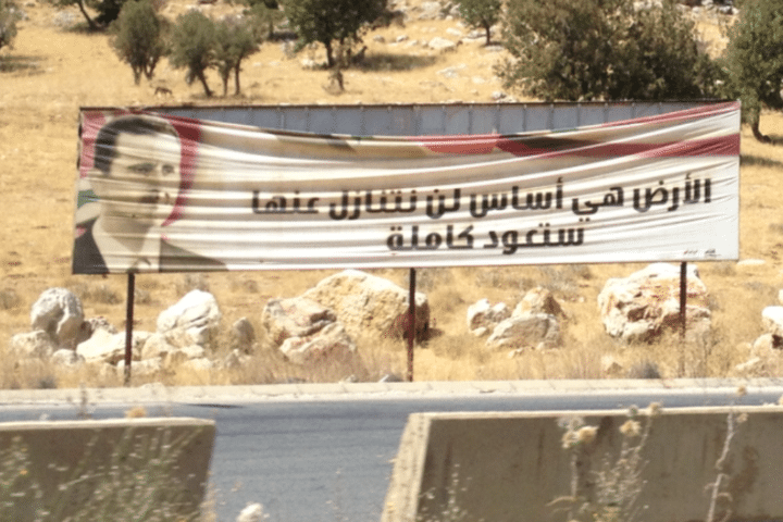 Un portrait de Bachar Al-Assad sur l'autoroute entre Damas et Homs, en Syrie, en sepembre 2013. (ALEX GOHARI / FRANCE 3)