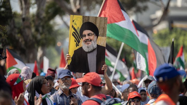 A protester holds up an image of leader Hassan Nasrallah, killed on September 28, in Cape Town, South Africa, October 5, 2024. (RODGER BOSCH / AFP)