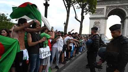 Des supporters de l'Algérie font face à des CRS, le 11 juillet 2019, après la victoire de leur équipe en quarts de finale. (DOMINIQUE FAGET / AFP)