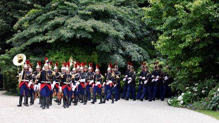 Des soldats français de la Garde républicaine arrivent au palais présidentiel de l'Élysée pour une cérémonie d'accueil du président sénégalais, à Paris, le 20 juin 2024. (LUDOVIC MARIN / AFP)