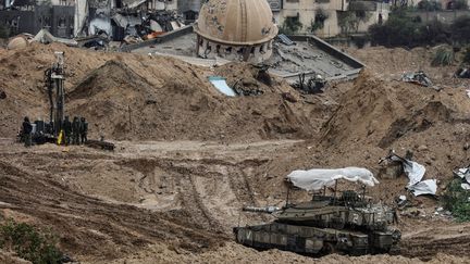 Une tournée médiatique organisée par l'armée israélienne montre un char de l'armée israélienne passant devant la mosquée Hamza endommagée dans l'al -District d'Amal de Khan Yunis, principale ville du sud de Gaza, le 27 janvier 2024. (NICOLAS GARCIA / AFP)