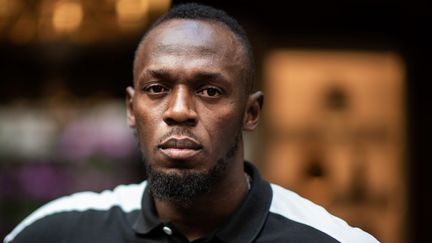 Usain Bolt lors du lancement de sa gamme de scooters électriques à Paris, le 15 mai 2019. (MARTIN BUREAU / AFP)