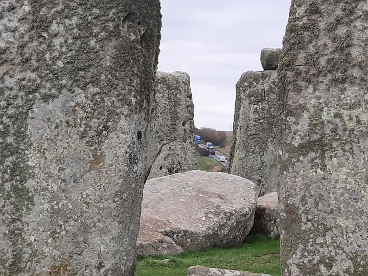 The A303 motorway is seen between the megaliths of the Stonehenge site, February 2024.  (Richard Place / Radio France)