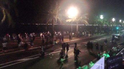 Une capture d'écran d'une vidéo postée sur Twitter montre des dizaines de personnes qui fuient l'attaque sur la promenade des Anglais à Nice (Alpes-Maritimes), le 14 juillet 2016. (HARP_DETECTIVES / TWITTER / AFP)