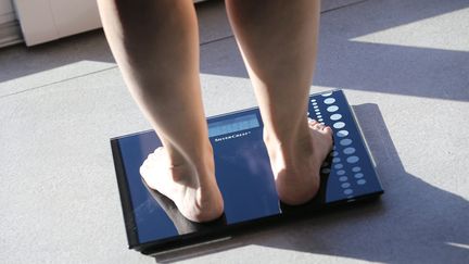 Une personne pèse son poids sur une balance (photo d'illustration). (JEAN-FRAN?OIS FREY / MAXPPP)