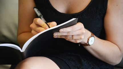 Une femme prend des notes. (JEAN-CHRISTOPHE BOURDILLAT / RADIO FRANCE)