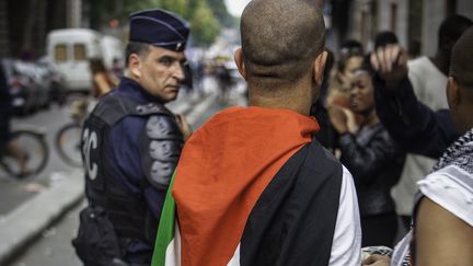 Un policier et un manifestant portant un drapeau palestinien, pendant le rassemblement pro-Gaza interdit &agrave; Paris, le 19 juillet 2014. (GUILLAUME GEYNET / CITIZENSIDE / AFP)