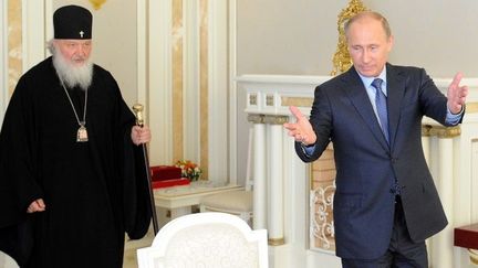 Le patriarche russe orthodoxe Kyrill et le président russe Vladimir Poutine, le 27 mai 2013, lors d'une rencontre à Sochi (Russie) avec les responsables de l'Eglise orthodoxe de Jérusalem et de Grèce. (YURI KADOBNOV / AFP )