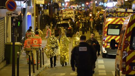 Des personnes sont évacuées rue d'Oberkampf à côté du Bataclan le soir de l'attaque terroriste du 13 novembre 2015. Photo d'illustration. (MIGUEL MEDINA / AFP)