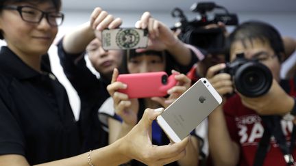 Un iPhone 5S est pr&eacute;sent&eacute; &agrave; des journalistes chinois &agrave; P&eacute;kin (Chine), le 11 septembre 2013. (JASON LEE / REUTERS)