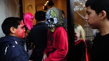 De jeunes habitants de New York sonnent aux portes pour avoir des bonbons le jour d'Halloween. (EMMANUEL DUNAND / AFP)