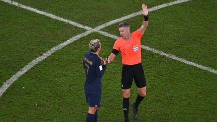 Le joueur de l'équipe de France, Antoine Griezmann, et l'arbitre Matthew Conger, lors de la rencontre face à la Tunisie, en Coupe du monde, le 30 novembre 2022. (ANTONIN THUILLIER / AFP)