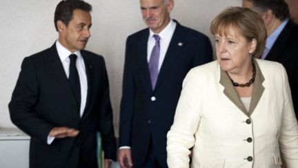 Nicolas Sarkozy, Georges Papandréou et Angela Merkel lors du sommet de l'UE à Bruxelles le 21 juillet à Bruxelles (AFP - BUNDESREGIERUNG - STEFFEN KUGLER)