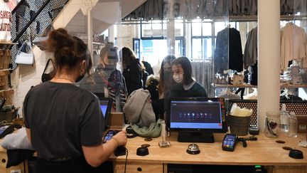 Des clients font leurs achats dans un magasin de vêtements le 28 novembre 2020 à Paris (photo d'illustration). (ALAIN JOCARD / AFP)