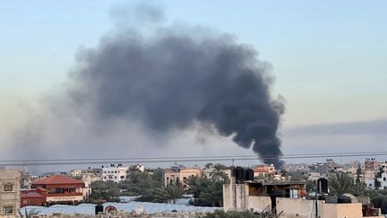 Smoke rises over buildings in Deir el-Balah, in the central Gaza Strip, during Israeli bombardments on January 10, 2024. (AFP)