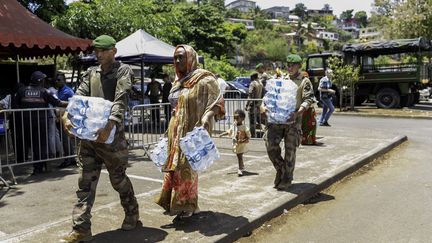 A distribution of water bottles in Mamoudzou, Mayotte, November 2, 2023. (MARION JOLY / AFP)