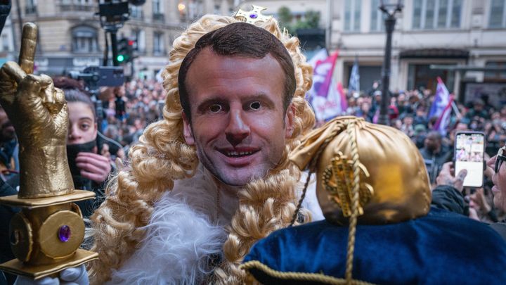 Un manifestant déguisé en roi porte le masque d'Emmanuel Macron, à Paris, le 17 avril 2023. (EDOUARD MONFRAIS-ALBERTINI / HANS LUCAS / AFP)