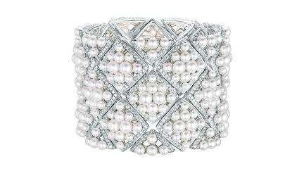 Signature de Chanel est la première collection de haute joaillerie dédiée au motif matelassé. Inspiré du monde équestre cher à Gabrielle Chanel et particulièrement par les vestes portées par les lads sur les champs de courses, le motif matelassé est incontournable de son univers créatif. Indéformable grâce à ses coutures entrecroisées, le motif matelassé permet à Gabrielle Chanel d’utiliser des matières souples comme le jersey, l’agneau ou la soie pour donner corps, volume et tenue à l’iconique sac 2.55. « L’élégance, c’est la ligne », aimait énoncer Mademoiselle Chanel pour donner davantage de fluidité et de liberté à sa silhouette. La géométrie de ces 48 pièces rend hommage à cette inspiration. Graphiques et épurées, elles expriment par la pureté de leurs lignes, la perfection dans la simplicité qui caractérise le style de Chanel. Le motif se compose ici de courbes et de volumes et se prête aux combinaisons les plus variées. Démultiplié, il tisse sa toile sur la surface entière du bijou pour le transformer en une matière tactile. Sensuels et flexibles, elles s’enroulent autour de la nuque, du doigt ou du poignet. Isolé, le carré galbé dévoile la finesse de ses contours pavés de diamants. Seul le bleu azuréen du saphir et de l’aigue-marine vient contraster, par touches, la blancheur lumineuse du diamant ou de l’or blanc. Les perles, la marqueterie de nacre grise et le cristal de roche complètent la collection. 
 (Chanel joaillerie, 2016)