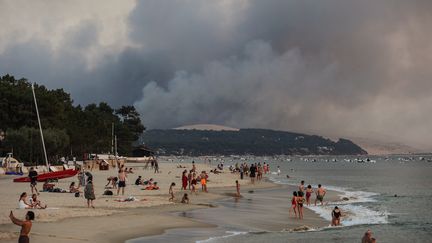 Des panaches de fumées liés à l'incendie de La Teste-sur-Buch aperçus depuis une place d'Arcachon, le 18 juillet 2022. (THIBAUD MORITZ / AFP)