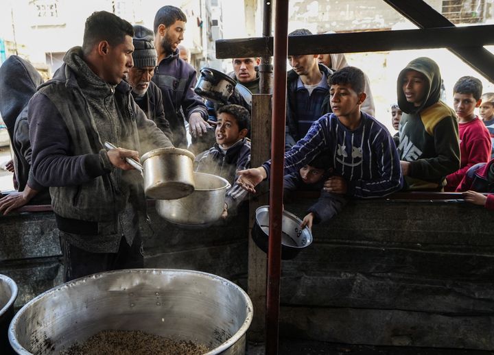 Children queue during a food aid distribution in Rafah, in the Gaza Strip, February 5, 2024. (BELAL KHALED / ANADOLU / AFP)