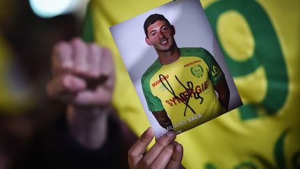 Un supporter brandit une photo dédicacée d'Emiliano Sala à Nantes (Loire-Atlantique), le 22 janvier 2019. (LOIC VENANCE / AFP)